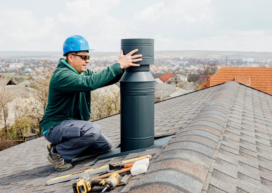 Chimney sweep at work near Pinehurst, TX