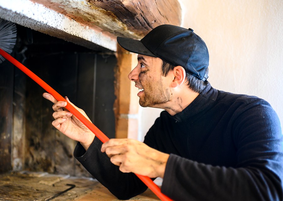 Chimney sweep at work near Falls City, TX